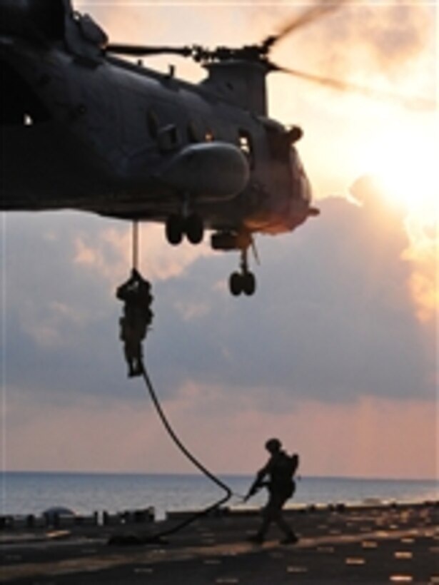 U.S. Marines assigned to the 13th Marine Expeditionary Unit drop from a CH-46 Sea Knight helicopter assigned to Marine Medium Squadron 163 to the flight deck of the amphibious assault ship USS Boxer (LHD 4) while conducting a fast-rope exercise in the Indian Ocean on March 24, 2011.  The Boxer is the flagship of the Boxer Amphibious Ready Group, which is underway with the 13th Marine Expeditionary Unit on a western Pacific Ocean deployment.  