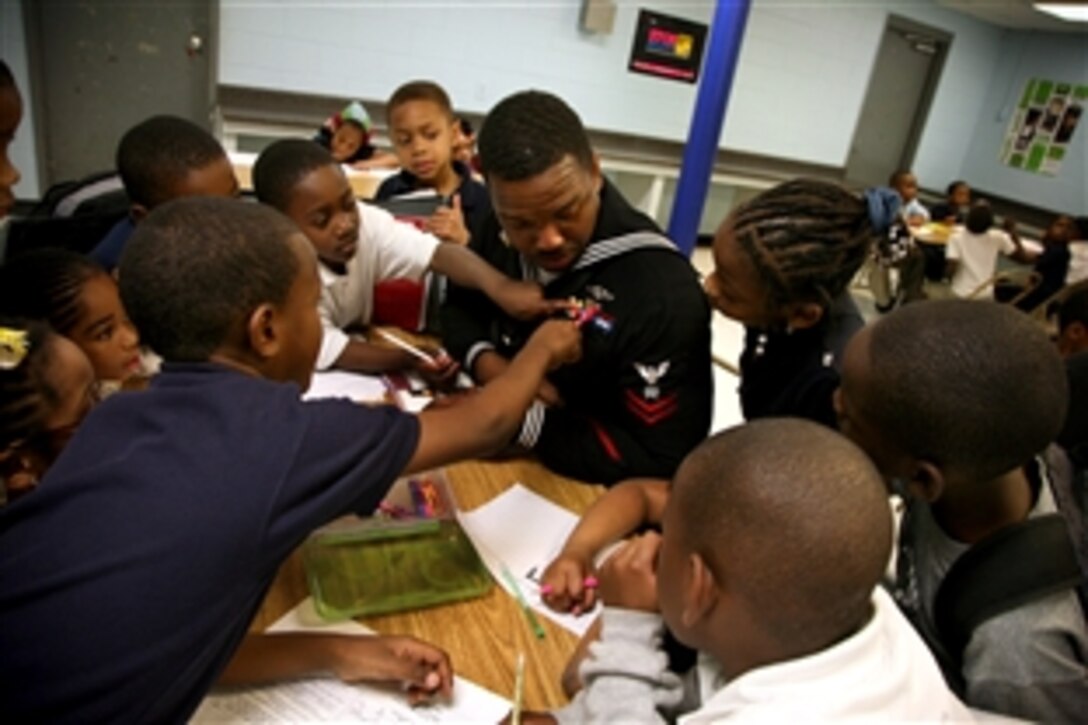 Navy Petty Officer 2nd Class Darrius Jenkins speaks with children at Central Mississippi Boys and Girls Club in Jackson, Miss., during Mississippi Navy Week, March 24, 2011.  Jenkins is assigned to the pre-commissioning unit of the attack submarine USS Mississippi.