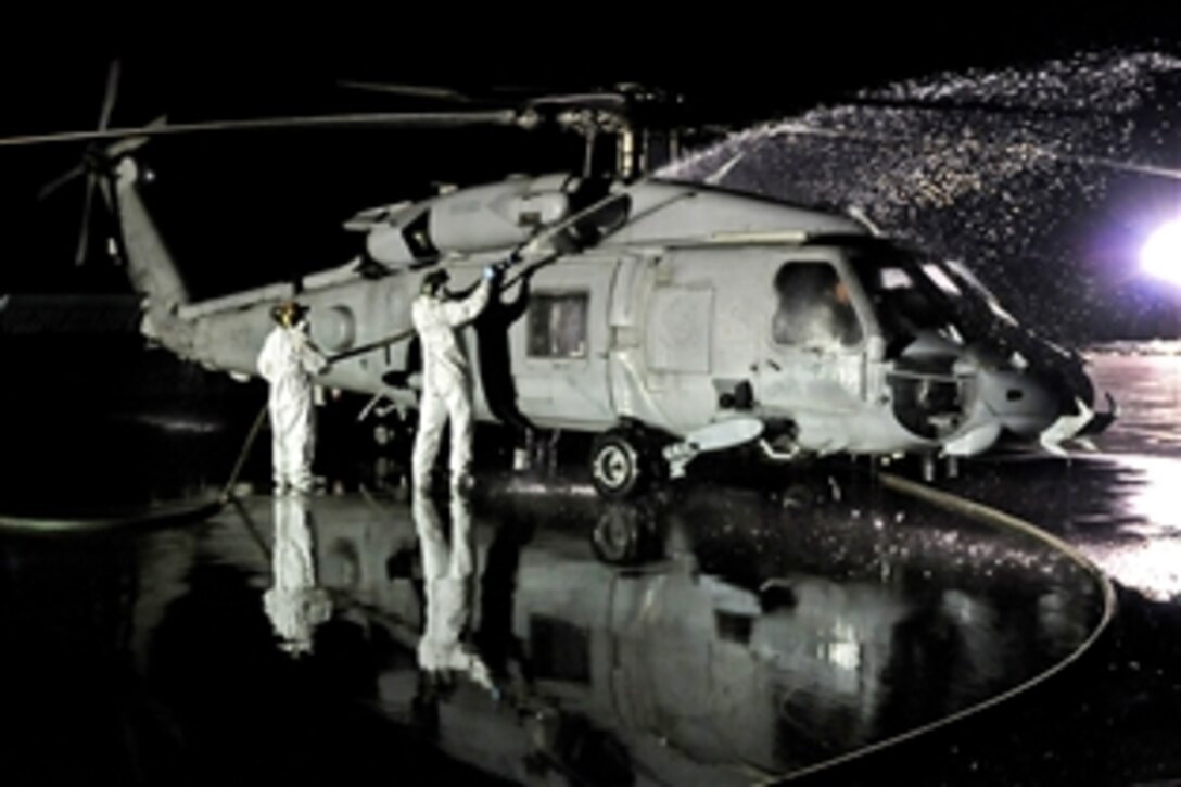 U.S. Navy sailors wash the exterior of an SH-60 Seahawk helicopter following an Operation Tomodachi humanitarian assistance mission, Misawa Air Base, Japan, March 23, 2011. The sailors are assigned to Helicopter Anti-Submarine Squadron 14 and Helicopter Anti-Submarine Squadron Light 51.