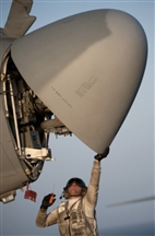 Petty Officer 3rd Class Andre Estrada, assigned to Electronic Attack Squadron 134, inspects the radar of an EA-6B Prowler aboard the flight deck of the aircraft carrier USS Carl Vinson (CVN 70).  The Carl Vinson Carrier Strike Group is deployed supporting maritime security operations and theater security cooperation efforts in the U.S. 5th Fleet area of responsibility.  