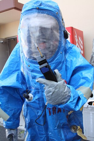 Yasushi Morikawa, Iwakuni Fire Department assistant fire chief and student in the Hazardous Material Technicians Course, tests a chemical zone of toxic chemicals at the Iwakuni Fire Department here March 30. Students were helped into HazMat suits and had to perform practical application during the five week course.