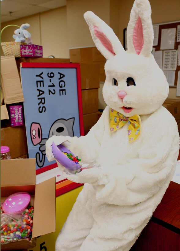 Corporal Antoine C. Hendon, who’s with Headquarters Battalion, 2nd Marine Division, wears a bunny suite while pouring candy for an Easter oriented event March 29, 2011, aboard Marine Corps Base Camp Lejeune, N.C. The free event is scheduled to take place at Lejeune’s W.P.T Field April 16, 2011, at 2 p.m., and will include food, clowns, face painting, and pony rides.