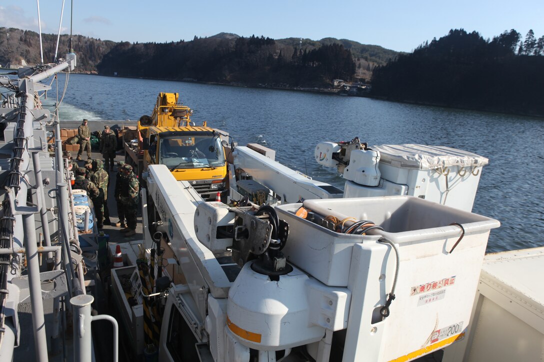 Japanese utility repair vehicles and personnel aboard a U.S. Navy landing craft head for the island of Oshima, March 27.  The 31st Marine Expeditionary Unit and Amphibious Squadron 11 picked up the vehicles from the port here and delivered food, water, comfort items and the vehicles to residents on the isolated island.  The island of Oshima has been cut off from the mainland since the earthquake and tsunami March 11.  The operation demonstrated the MEU’s expeditionary capabilities in ship-to-shore amphibious operations. Marines and Sailors of the 31st MEU are conducting humanitarian aid and disaster relief missions in northeast Japan assisting the Japanese Self Defense Forces in their ongoing operations.