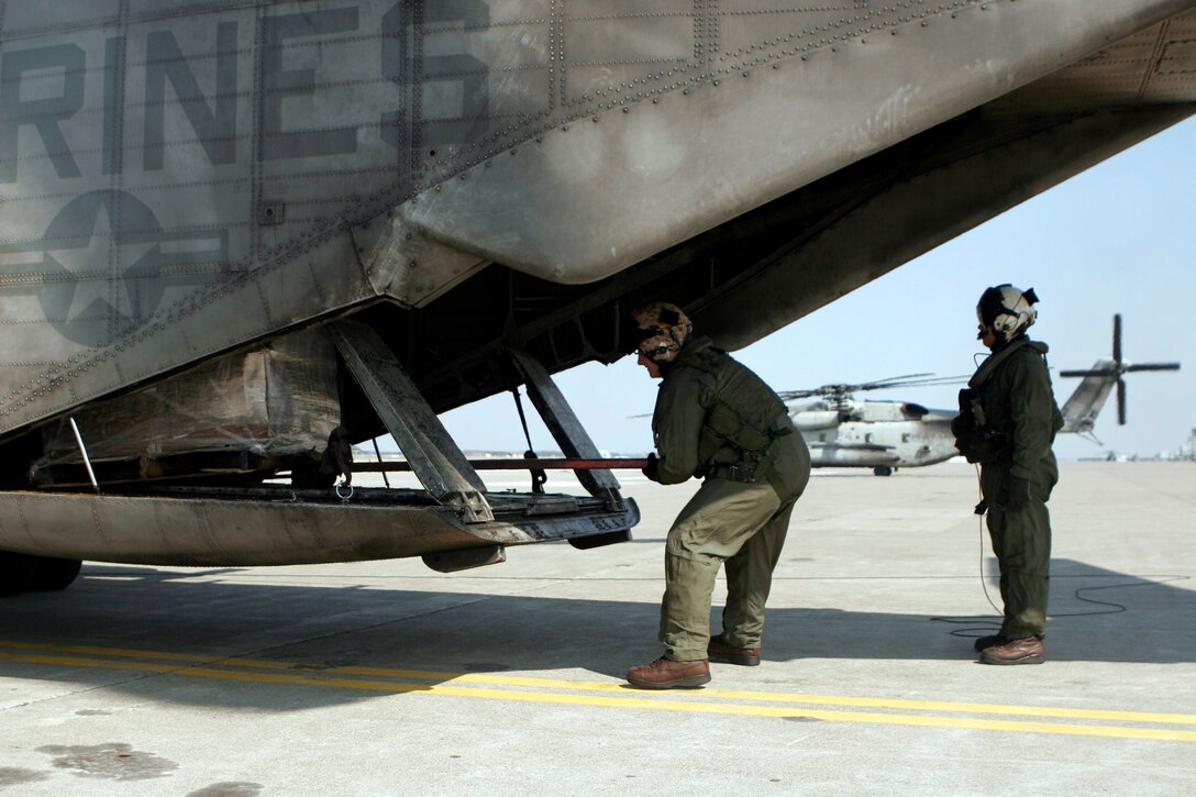 Staff Sgt. Ian J. Huffman (left), and Staff Sgt. Terrance W. Clark (right), crew chiefs with Marine Medium Helicopter Squadron 262 (Reinforced), 31st Marine Expeditionary Unit, unload a pallet of supplies from a CH-53E Super Stallion helicopter, March 29. The supplies were delivered to Misawa, Japan, and used to support humanitarian aid and disaster relief operations currently in progress. The 31st MEU’s involvement is part of a larger U.S. government response, after a 9.0 earthquake and subsequent tsunami struck Japan causing widespread damage. The 31st MEU is ready to support our Japanese partners and to provide assistance when called upon.