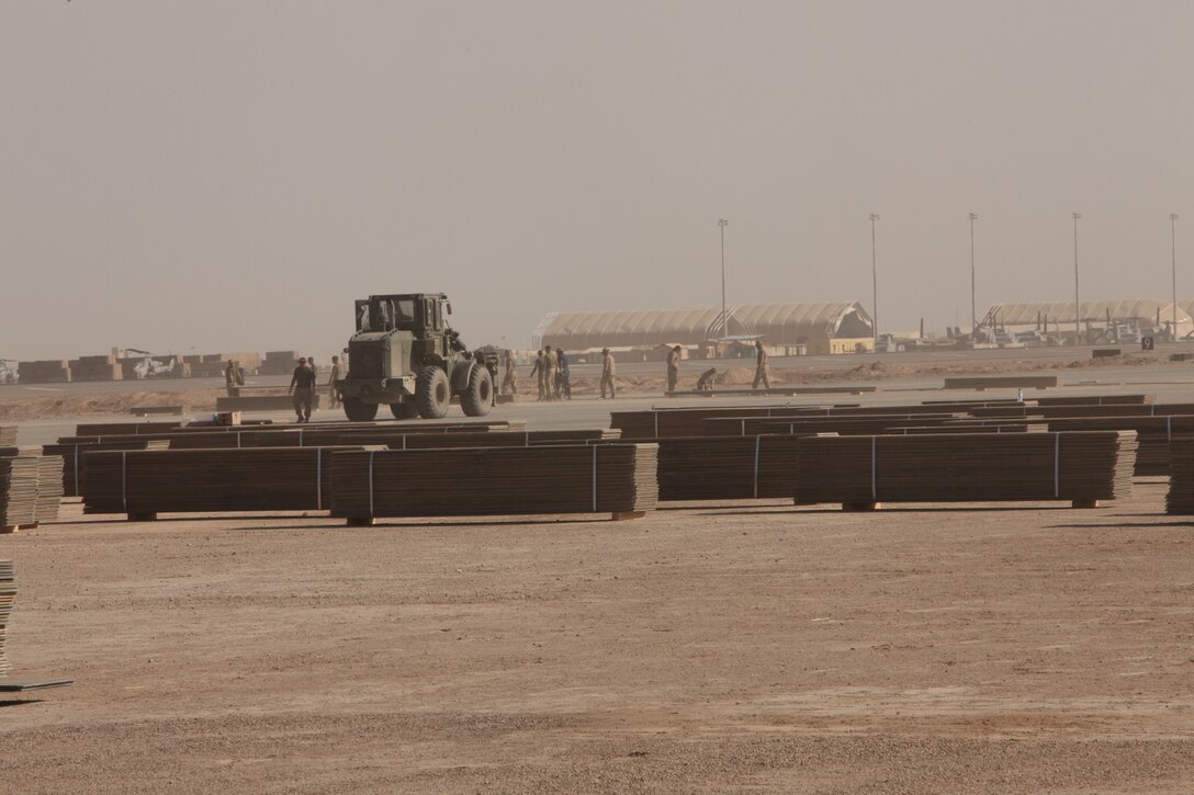 Marines with Marine Wing Support Squadron 272 remove worn down aluminum matting from an inactive flight line on Camp Bastion, Afghanistan, March 29. Once the aluminum matting is removed a permanent runway will be constructed in its place. The Marines of MWSS-272 will move more than 3 million square feet of matting over the next several months as they complete the job. MWSS-272 is deployed out of Marine Corps Air Station New River, N.C. in support of 2nd Marine Aircraft Wing (Forward).