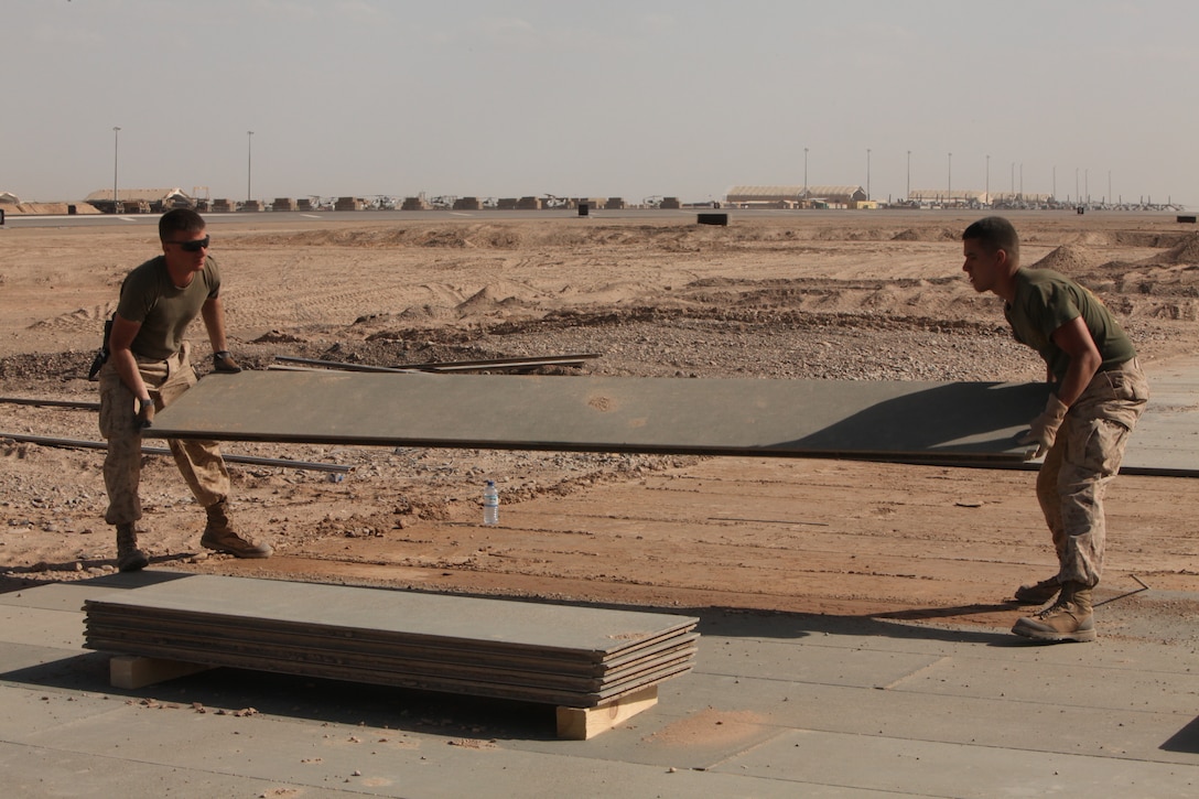 Marines with Marine Wing Support Squadron 272 remove worn down aluminum matting from an inactive flight line on Camp Bastion, Afghanistan, March 29. Once the aluminum matting is removed a permanent runway will be constructed in its place. The Marines of MWSS-272 will move more than 3 million square feet of matting over the next several months as they complete the job. MWSS-272 is deployed out of Marine Corps Air Station New River, N.C. in support of 2nd Marine Aircraft Wing (Forward).