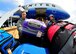 Air Force personnel remove luggage from an aircraft carrying Air Force and Navy families returning from Japan during Operation Pacific Passage operations on March 25, 2011, at Travis Air Force Base, Calif. Operation Pacific Passage gives military families the opportunity to voluntarily relocate from Japan to a safe haven in the U.S. in order to conserve Japanese resources. (U.S. Navy Photo/Mass Communication Specialist 2nd Class Eddie Harrison)