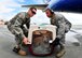 Airman 1st Class Douglas Raque (left) and Senior Airman Jerret Lampley, attached to 571st Global Mobility Squadron, lift a pet as it was just belted from an aircraft carrying Air Force and Navy families returning from Japan during Operation Pacific Passage operations at Travis Air Force Base, Calif., on March 25, 2011. Operation Pacific Passage gives military families the opportunity to voluntarily relocate from Japan to a safe haven in the U.S. in order to conserve Japanese resources. (U.S. Navy Photo/Mass Communication Specialist 2nd Class Eddie Harrison)