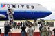 U.S. Air Force and Navy personnel wait to assist military families exiting an aircraft arriving from Japan during Operation Pacific Passage operations on March 25,2011, at Travis Air Force Base, Calif. Operation Pacific Passage gives military families the opportunity to voluntarily relocate from Japan to a safe haven in the U.S. in order to conserve Japanese resources. (U.S. Navy photo by Mass Communication Specialist 2nd Class Eddie Harrison/Released)