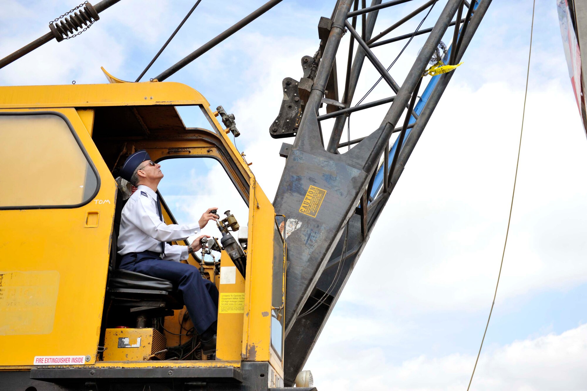 Colonel Udo McGregor, 452nd Air Mobility Wing commander, operates a crane carrying a 5,000-pound wrecking ball to punch the first hole into the roof of the former March Air Force Base hospital building at a deconstruction ceremony here Tuesday, March 22.  The demolition paves the way for the $3.3 billion March LifeCare campus.  (Photo courtesy of Matthew Smith)
