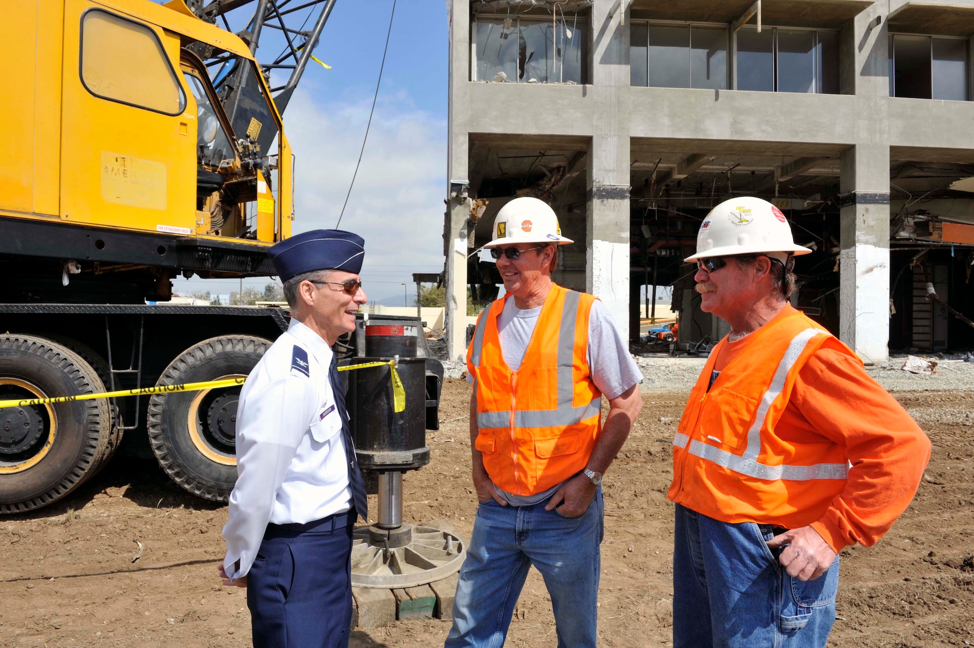 Colonel Udo McGregor, 452nd Air Mobility Wing commander, talks with two employees of U.S. Demolition prior to the deconstruction ceremony for the old March hospital building here Tuesday, March 22.  Col McGregor will operate a crane sending the first crash of a 5,000 pound wrecking ball through the roof to start the demolition, which will pave the way for the $3.3 billion March LifeCare campus.  (Photo courtesy of Matthew Smith)