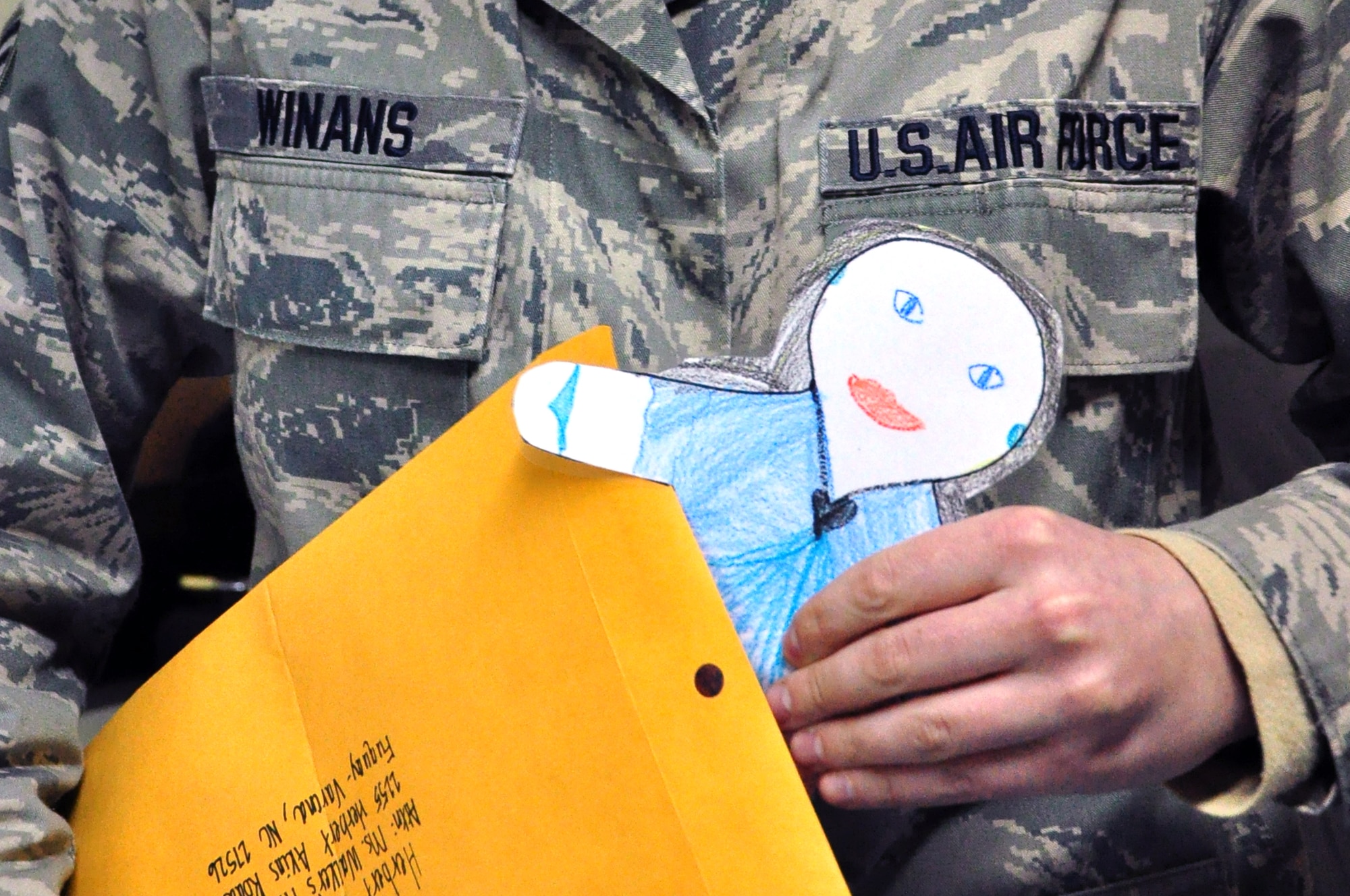 Flat Stanley is placed in his envelope for his trip home to North Carolina by his guardian Staff Sgt. Mindy Winans, 376th Expeditionary Contracting Squadron, Transit Center at Manas, Kyrgyzstan. Upon arriving at the Transit Center, Flat Stanley has been spotted participating in a number of Transit Center activities  including flying a KC-135 Stratotanker refuel mission, riding with cargo on a forklift, visiting a local village school and  interacting with the transients who pass through here on their way to and from Afghanistan. (U.S. Air Force photo/Master Sgt. Daniel Nathaniel)