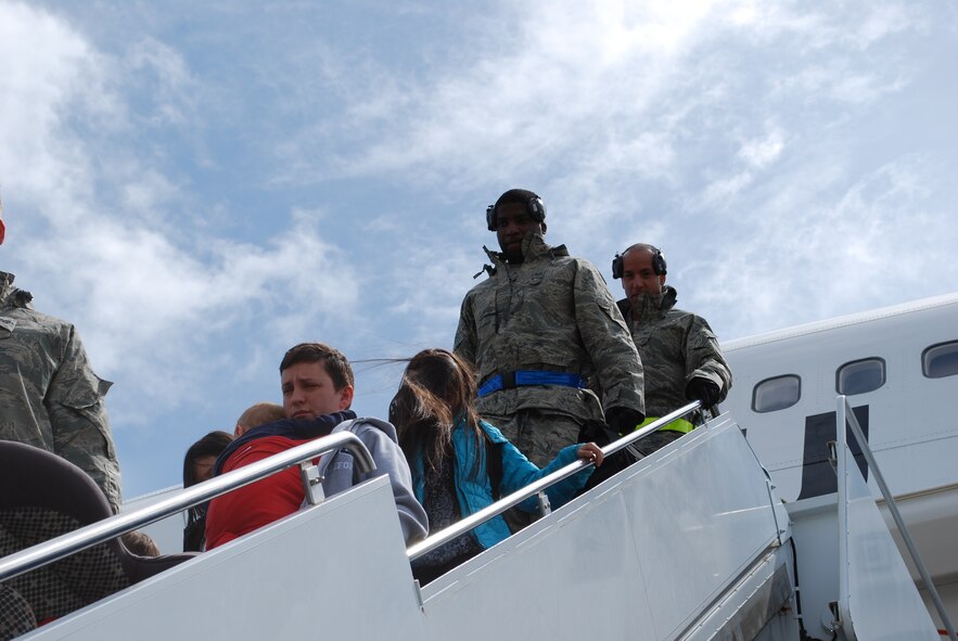Military family members, their pets, Airmen and other service members process through Travis Air Force Base, Calif., on March 25, 2011, as part of Operation Pacific Passage. Shortly after an 8.9-magnitude earthquake and subsequent tsunami struck Japan on March 11, 2011, Department of Defense officials approved voluntary departures for DOD personnel and family members to return to the United States. U.S. Northern Command was the lead for the departure operation -- naming it "Operation Pacific Passage." According to USNORTHCOM Public Affairs, Travis AFB, Seattle-Tacoma IAP , Wash., and Denver International Airport, Colo., were the main arrival locations. (U.S. Air Force Photo)
