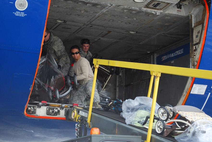 Military family members, their pets, Airmen and other service members process through Travis Air Force Base, Calif., on March 25, 2011, as part of Operation Pacific Passage. Shortly after an 8.9-magnitude earthquake and subsequent tsunami struck Japan on March 11, 2011, Department of Defense officials approved voluntary departures for DOD personnel and family members to return to the United States. U.S. Northern Command was the lead for the departure operation -- naming it "Operation Pacific Passage." According to USNORTHCOM Public Affairs, Travis AFB, Seattle-Tacoma IAP , Wash., and Denver International Airport, Colo., were the main arrival locations. (U.S. Air Force Photo)
