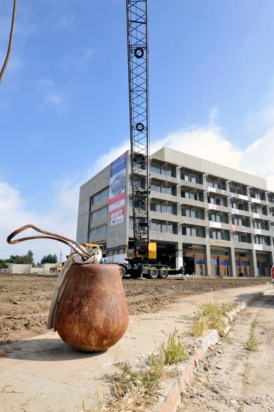 A 5,000-pound wrecking ball sits ready for work as the shell of what used to be the March Air Force Base Hospital stands for the final time in the background.   Demolition began on the March hospital building during a deconstruction ceremony Tuesday, March 22, to make way for the $3.3 billion March LifeCare campus.  (Photo courtesy of Matthew Smith)
