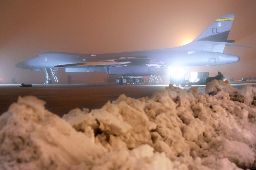 Airmen of the 28th Aircraft Maintenance Squadron prepare a B-1B Lancer to support Operation Odyssey Dawn on Ellsworth Air Force Base, S.D., March 27, 2011.   Their work was made especially difficult by severe weather conditions including snow, ice, and freezing fog. (U.S. Air Force photo/Staff Sgt. Marc I. Lane)