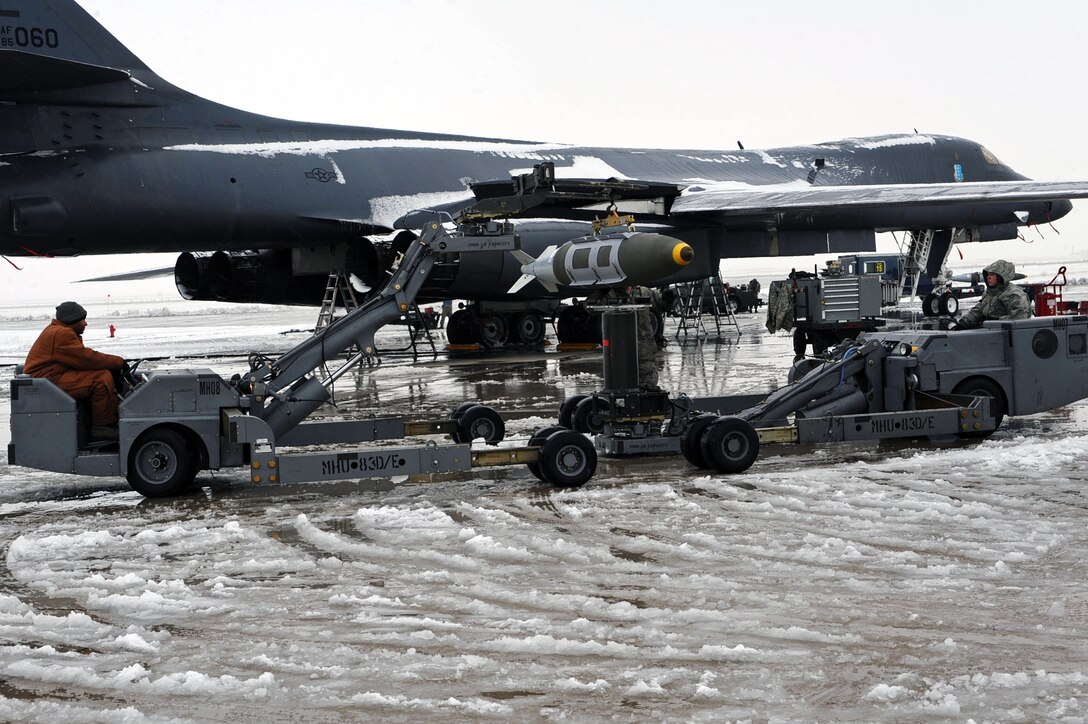 Airmen from the 28th Aircraft Maintenance Squadron transfer a two thousand pound bomb from a weapons trailer to the load jammer in preparation of Operation Odyssey Dawn at Ellsworth Air Force Base, S.D., March 26, 2011. Once secure on the load jammer, the two thousand pound bomb will then be loaded into the aircraft bomb bay. (U.S. Air Force photo/Senior Airman Kasey Close)