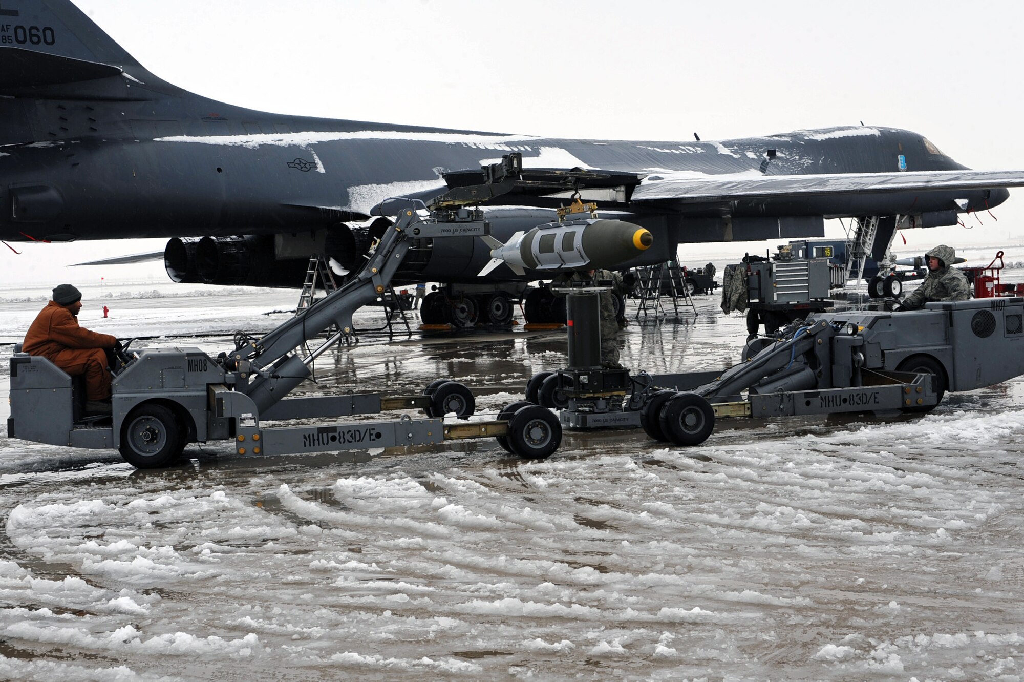 Airmen from the 28th Aircraft Maintenance Squadron transfer a two thousand pound bomb from a weapons trailer to the load jammer in preparation of Operation Odyssey Dawn at Ellsworth Air Force Base, S.D., March 26, 2011. Once secure on the load jammer, the two thousand pound bomb will then be loaded into the aircraft bomb bay. (U.S. Air Force photo/Senior Airman Kasey Close)