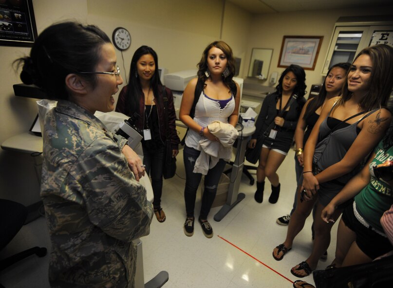 Maj. Jaime Okamura, Optometry flight commander, speaks to Radford High School students about opthalmology Mar. 24 at the 15th Medical Group during a tour of various facilities at Joint Base Pearl Harbor-Hickam, Hawaii. During the visit, the RHS students visited various locations on base including the C-17 Operations building, C-17 simulator, fitness center, and the child development center. (U.S. Air Force photo by Airman 1st Class Lauren Main)