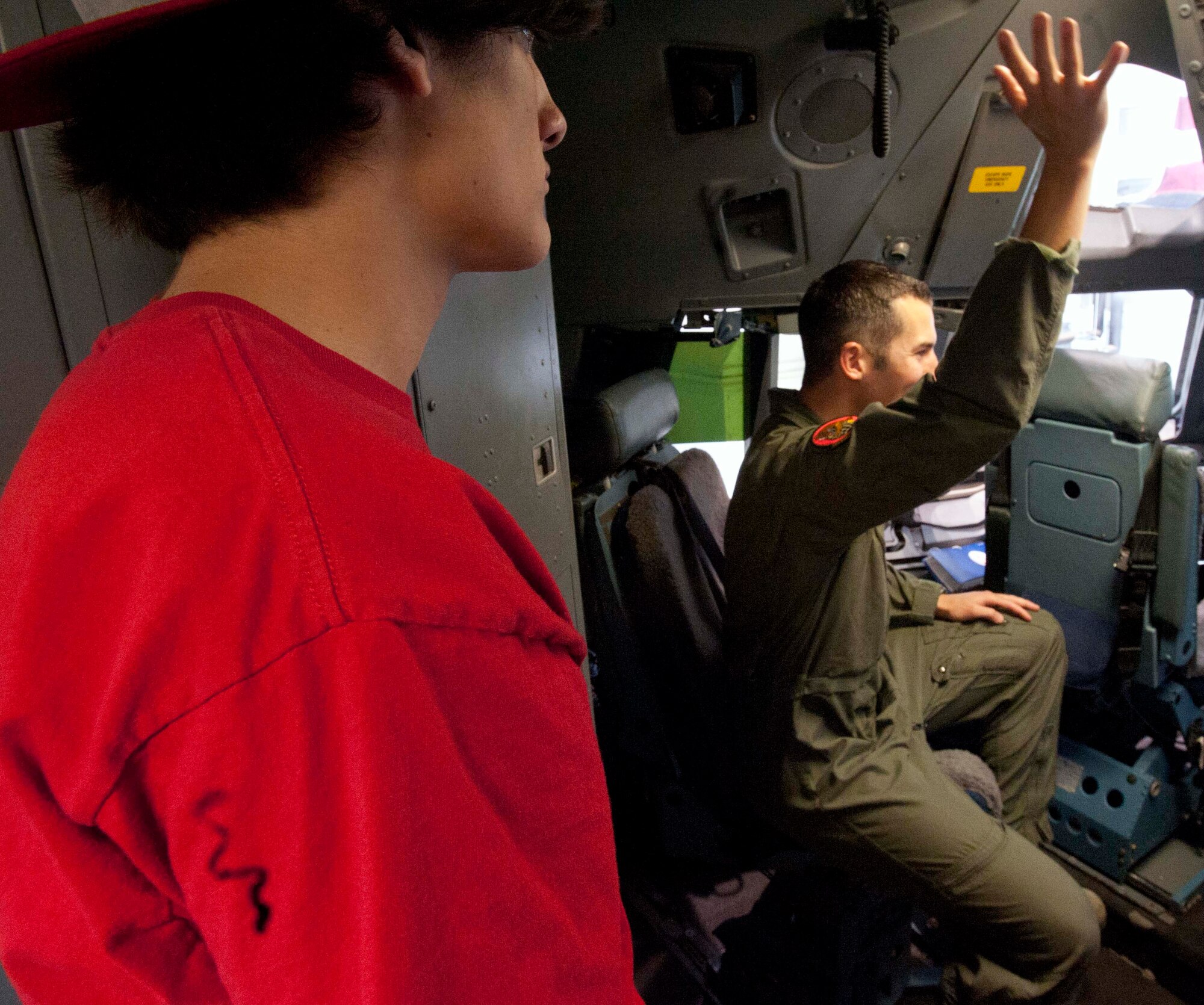 1st Lt. Andy Putnam, 535th Airlift Squadron pilot, discusses what it's like to be a pilot as Miguel Lozada, a Radford High School student, listens in Mar. 24 at Joint Base Pearl Harbor-Hickam, Hawaii. During the visit, the RHS students visited various locations on base including the C-17 Operations building, C-17 simulator, fitness center, and the child development center. (U.S. Air Force photo by Staff Sgt. Nathan Allen)