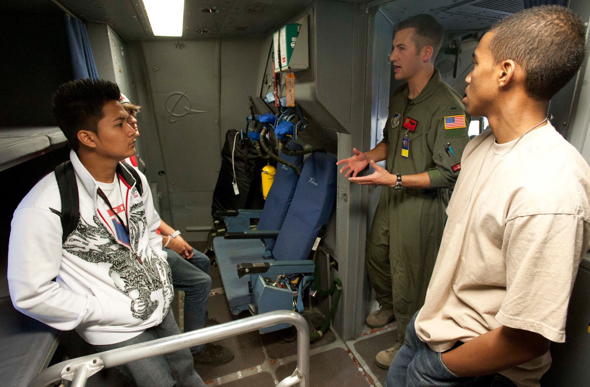 1st Lt. Andy Putnam, 535th Airlift Squadron pilot, discusses what it's like to be a pilot with with John Christian Hew Len (left) and Derek Jones,  Radford High School students, Mar. 24 at Joint Base Pearl Harbor-Hickam, Hawaii. During the visit, the RHS students visited various locations on base including the C-17 Operations building, C-17 simulator, fitness center, and the child development center. (U.S. Air Force photo by Staff Sgt. Nathan Allen)