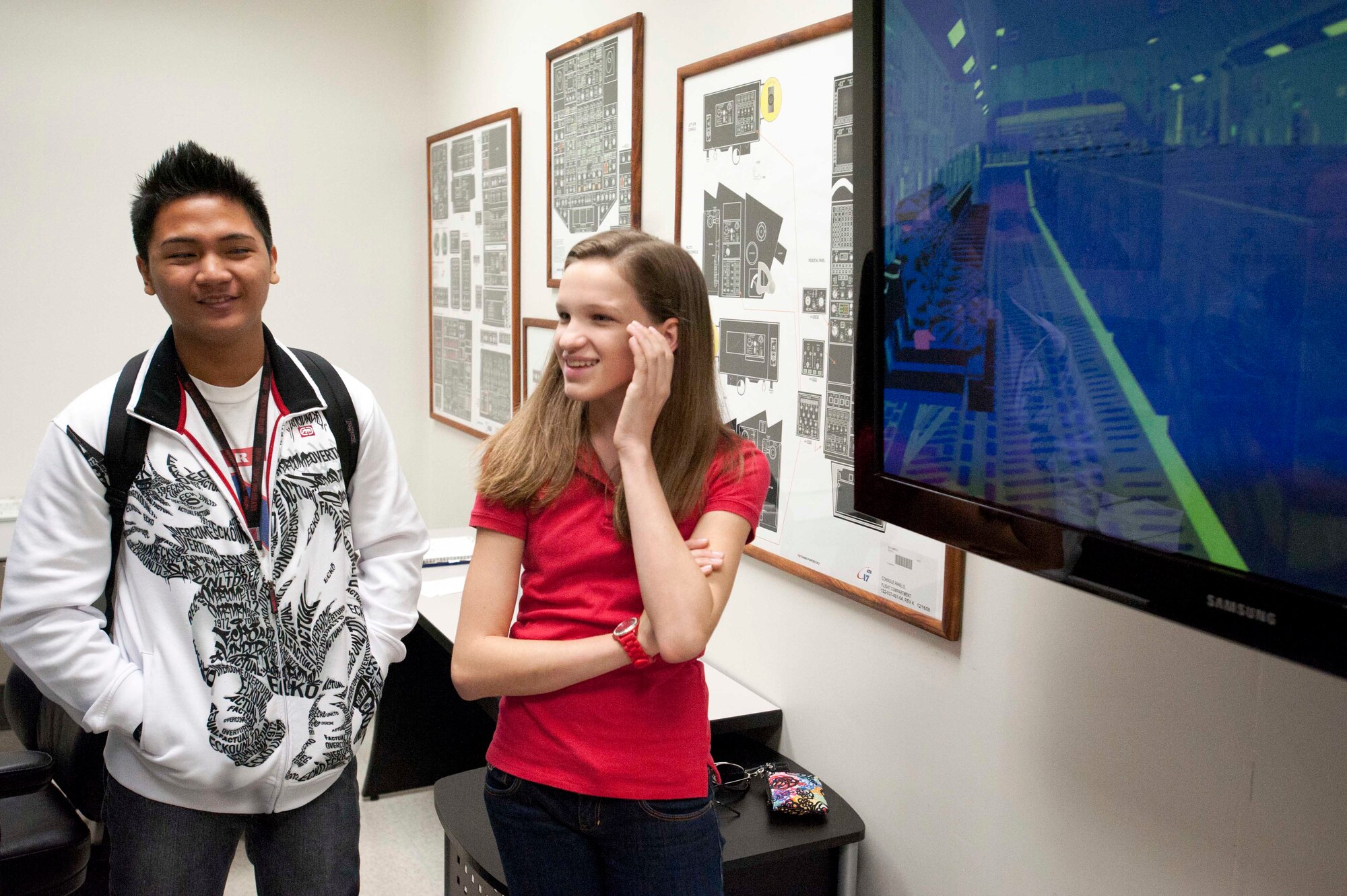 John Christian Hew Len (left), and Madeline Skrocki, Radford High School students, share a laugh in the C-17 Loadmaster training room Mar. 24 at Joint Base Pearl Harbor-Hickam, Hawaii. During the visit, the RHS students visited various locations on base including the C-17 Operations building, C-17 simulator, fitness center, and the child development center. (U.S. Air Force photo by Staff Sgt. Nathan Allen)
