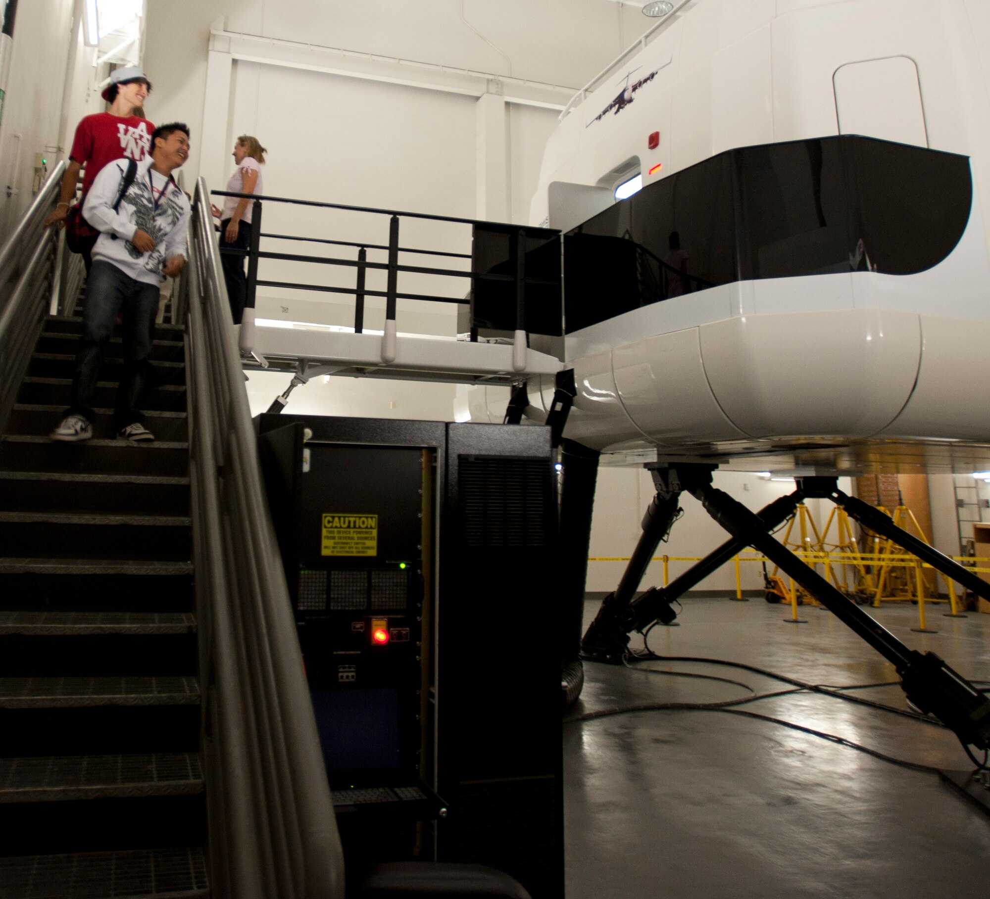 Radford High School students exit the C-17 flight simulator Mar. 24 at Joint Base Pearl Harbor-Hickam, Hawaii. During the visit, the RHS students visited various locations on base including the C-17 Operations building, C-17 simulator, fitness center, and the child development center. (U.S. Air Force photo by Staff Sgt. Nathan Allen)