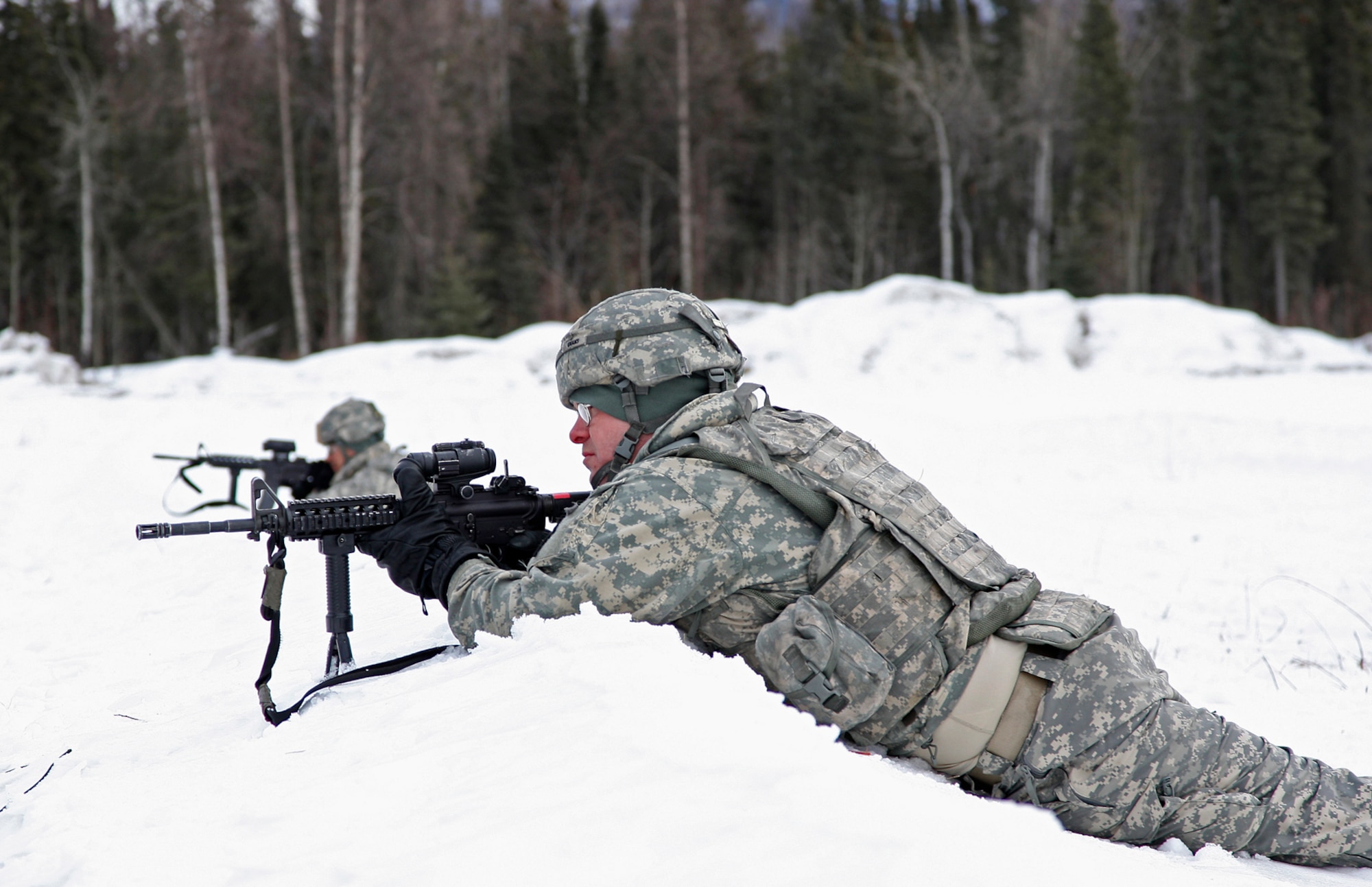 Soldiers from Alpha Battery 2-377 PFAR set up a perimeter guard as they await inbound M119A2 Howitzers and additional Soldiers during an air assualt raid.