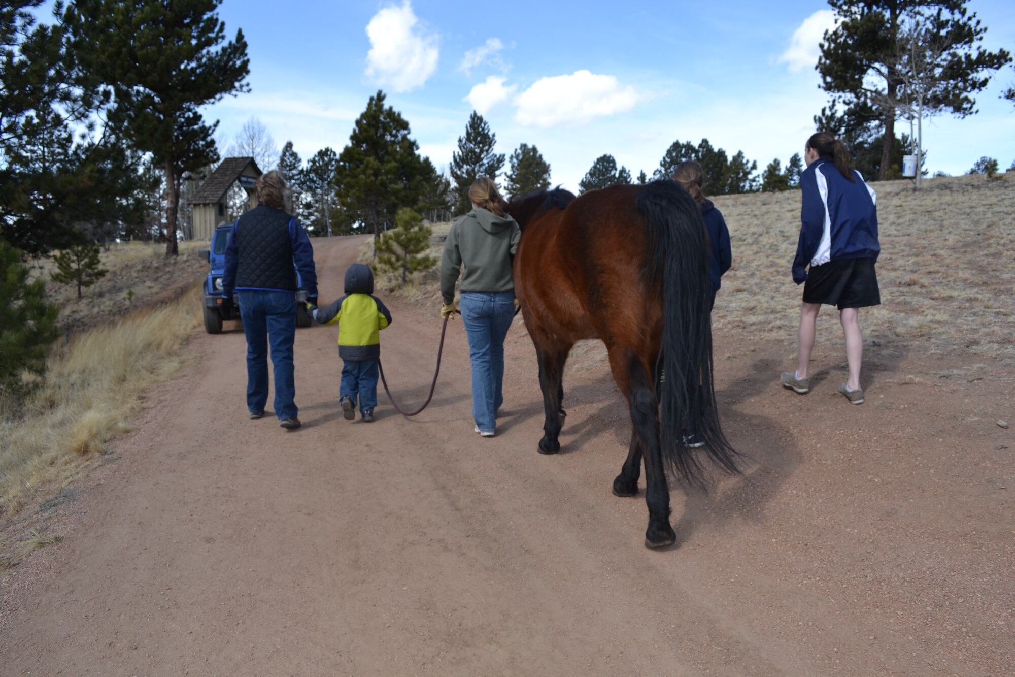 One Peterson family enjoys a walk with a horse during a recent retreat at the Christ Haven Lodge in Florissant, Colo. The lodge owners invited five Peterson families with special needs children to stay at the lodge and enjoy horseback riding, swimming, and parent support groups. The retreat is for the entire family, including siblings that may not have disabilities. The lodge owners worked with Peterson’s Exceptional Family Member Program coordinator Jackie Wickham, who hopes to send 40 families to the retreats throughout the year. (Courtesy photo)