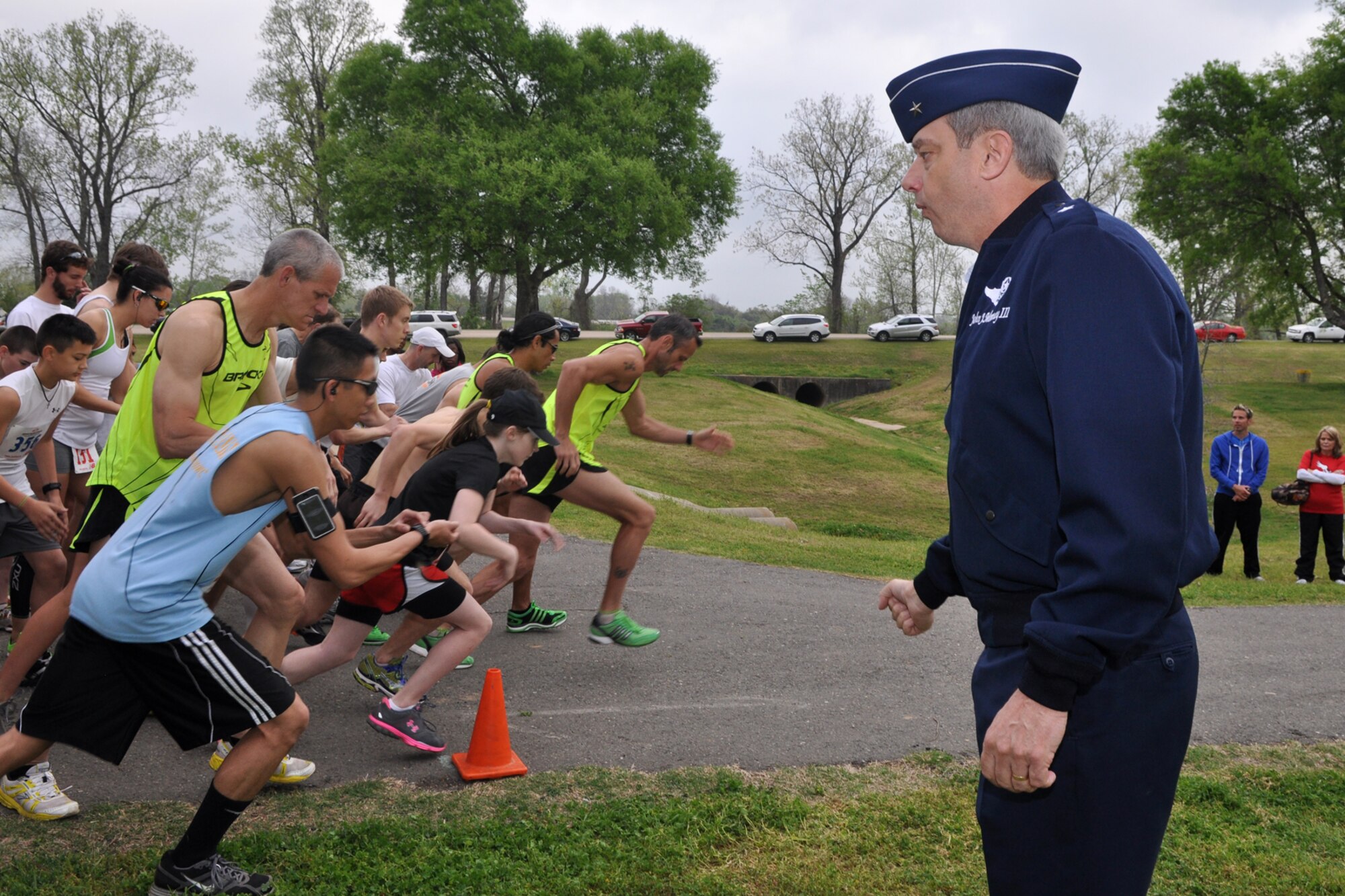 With the motion of a hand, Brig. Gen. John J. Mooney III, commander, 307th Bomb Wing, Barksdale Air Force Base, La., starts the Overton Brooks VA Medical Center’s 2nd Annual Warrior Run at Veterans Park in Shreveport, La., March 26, 2011. General Mooney offered words of encouragement to the 596 participants who registered for the event, asking them not to forget the warriors who are sacrificing in harm's way as they enjoyed the beautiful morning at the race. The proceeds raised at the event will support OBVAMC Voluntary Service programs such as: homeless Veteran services, rehabilitation equipment, social service assistance, comfort items, transportation, holiday gifts and other volunteer funded services. (U.S. Air Force photo/Tech. Sgt. Jeff Walston)