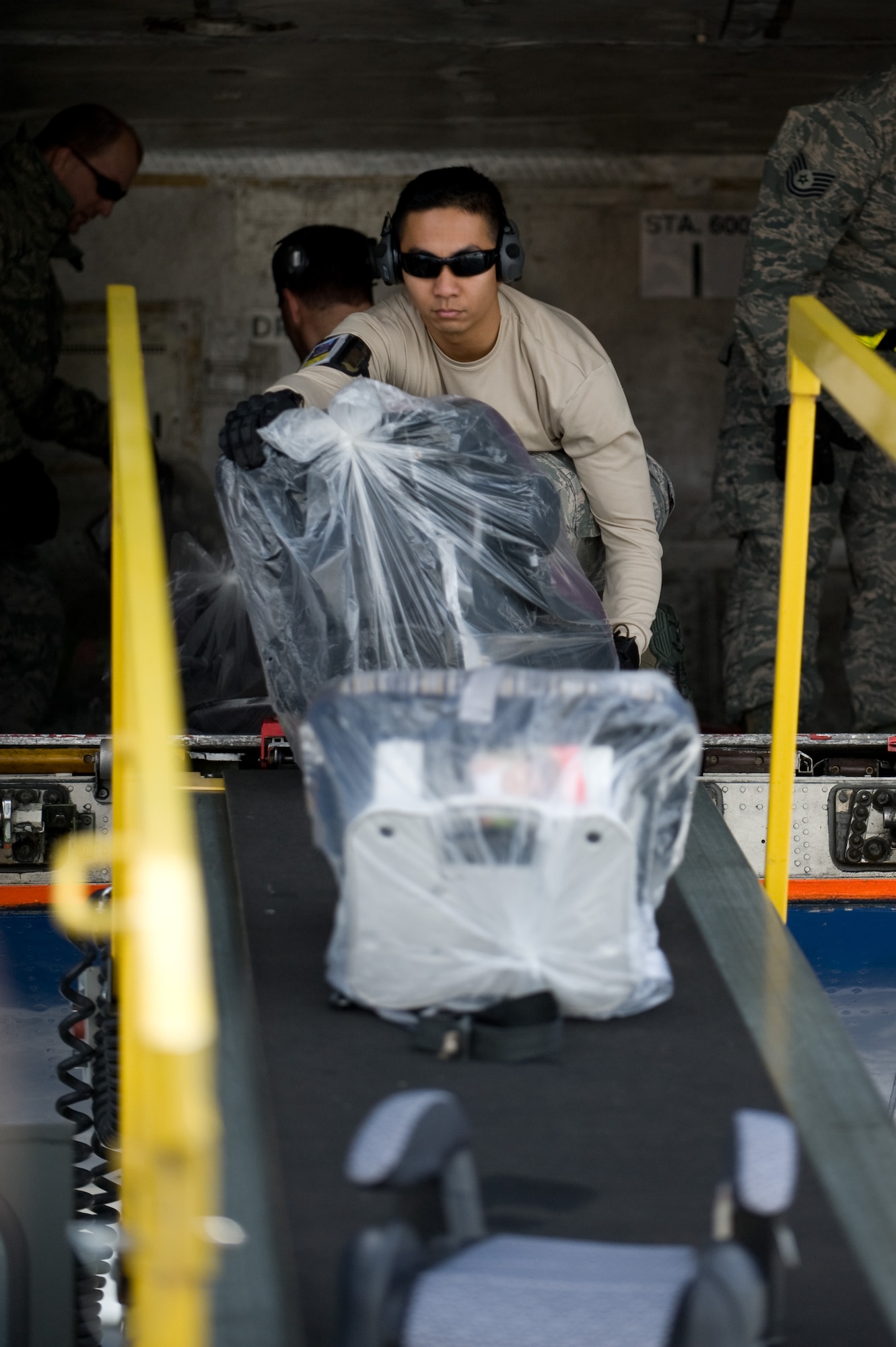 Baggage is unloaded from a chartered aircraft that arrived at Travis Air Force Base, Calif., on March 25, 2011 from Japan. Following the earthquake and tsunami that hit Japan on March 11, hundreds of family members from military bases in Japan voluntarily relocated to the United States after radiation from crippled Japanese nuclear energy plants was detected in some areas.(U.S. Air Force photo/Ken Wright)
