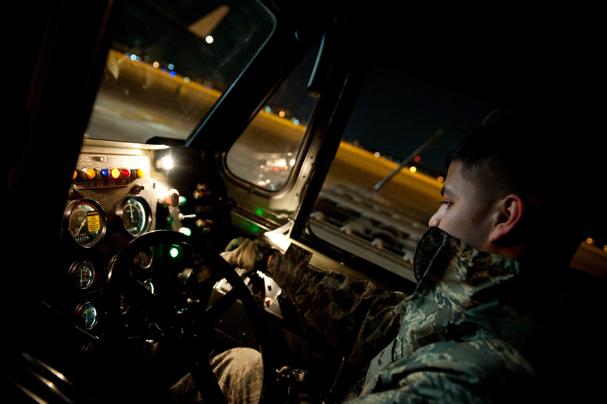 YOKOTA AIR BASE, Japan -- An Airman from the 730th Air Mobility Squadron operates a K-loader while unloading a C-17 Globemaster III here March 29. The C-17 carried water pumps and hoses to help stabilize the nuclear power plant in Japan in support of Operation Tomodachi. (U.S. Air Force photo/Staff Sgt. Chad C. Strohmeyer)