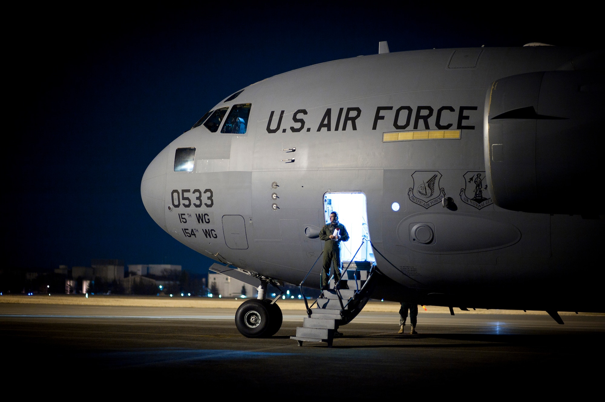 YOKOTA AIR BASE, Japan -- A C-17 Globemaster III sits on the flight line after arriving from Guam here March 29. The C-17 carried water pumps and hoses to help stabilize the nuclear power plant in Japan in support of Operation Tomodachi. (U.S. Air Force photo/Staff Sgt. Chad C. Strohmeyer)