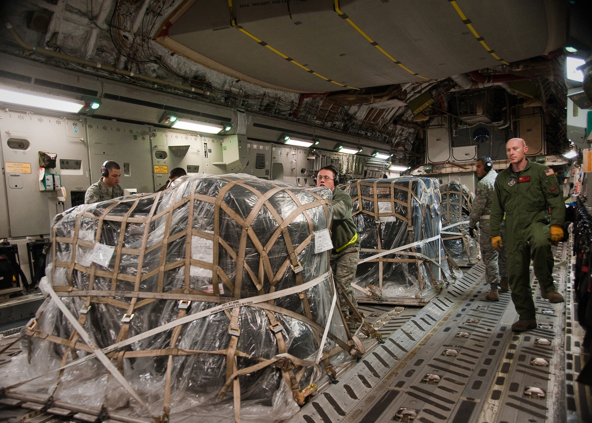 YOKOTA AIR BASE, Japan -- Airmen from the 730th Air Mobility Squadron unload water pumps and hoses off a C-17 Globemaster III here March 30, 2011. The aircraft delivered 20,000 pounds of cooling equipment for the Fukushima nuclear plant. (U.S. Air Force photo/Airman 1st Class Andrea Salazar)