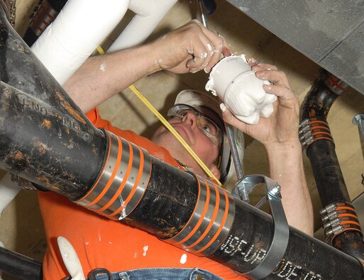 Lewis Thorpe, contractor, seals pipes March 29, 2011, at the Dover Air Force Base, Del., Medical Clinic. The renovations began July 2010 and are scheduled to be complete December 2011. (U.S. Air Force photo by Airman 1st Class Samuel Taylor)
