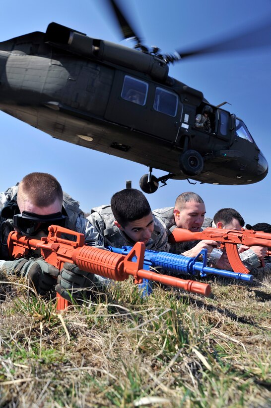 11th Security Forces Group Airmen provide cover while a UH-60 Black Hawk takes off during helicopter deployment readiness training March 25, 2011, at Davison Army Airfield, Va. Airmen are increasingly traveling by helicopter to avoid improvised explosive devices and direct gun fire associated with road convoys in a deployed environment. This training program gives them the confidence to execute their core job and not be distracted by the noise, confusion and unfamiliarity of tactical joint air operations.  (U.S. Air Force Photo by Senior Airman Perry Aston) (Released)