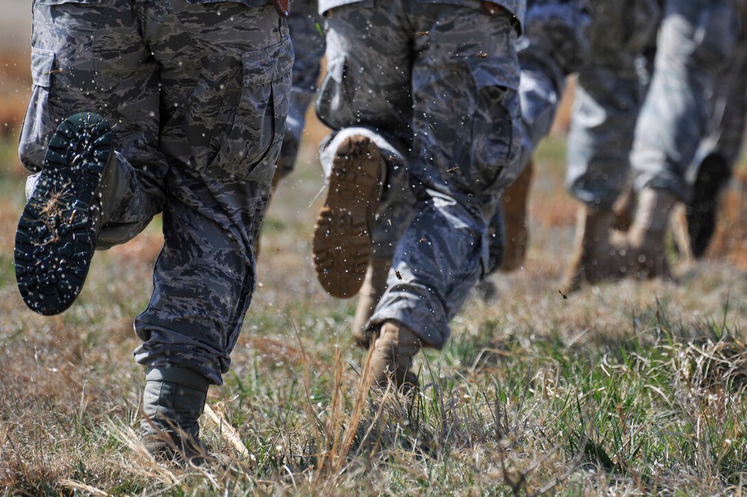 Airmen run toward a UH-60 Black Hawk helicopter during helicopter deployment readiness training March 25, 2011, at Davison Army Airfield, Va. The training will better familiarize deploying Airmen to tactical joint air operations. (U.S. Air Force Photo by Senior Airman Perry Aston) (Released)