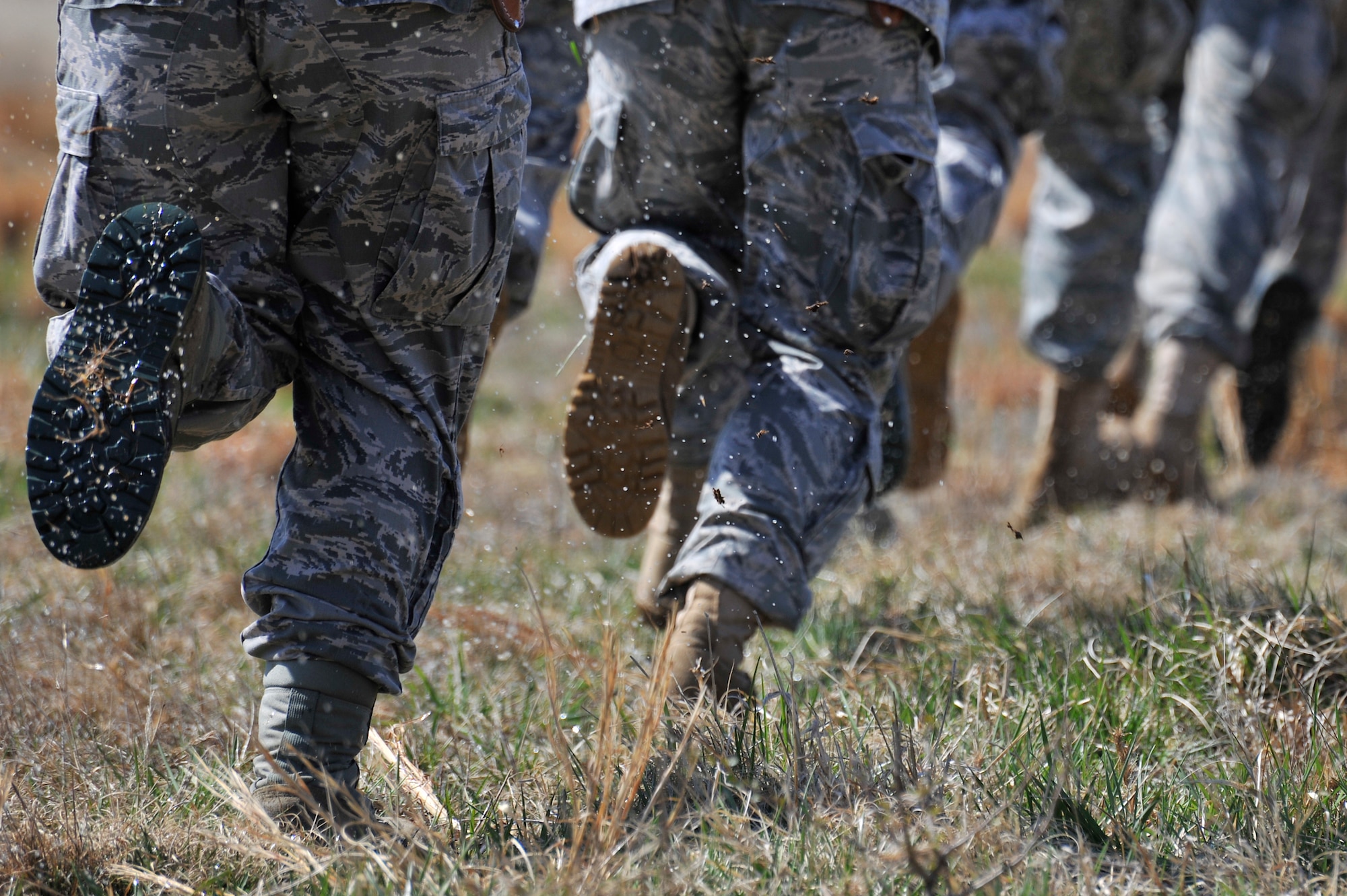 Airmen run toward a UH-60 Black Hawk helicopter during helicopter deployment readiness training March 25, 2011, at Davison Army Airfield, Va. The training will better familiarize deploying Airmen to tactical joint air operations. (U.S. Air Force Photo by Senior Airman Perry Aston) (Released)