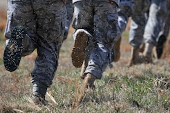 Airmen run toward a UH-60 Black Hawk helicopter during helicopter deployment readiness training March 25, 2011, at Davison Army Airfield, Va. The training will better familiarize deploying Airmen to tactical joint air operations. (U.S. Air Force Photo by Senior Airman Perry Aston) (Released)
