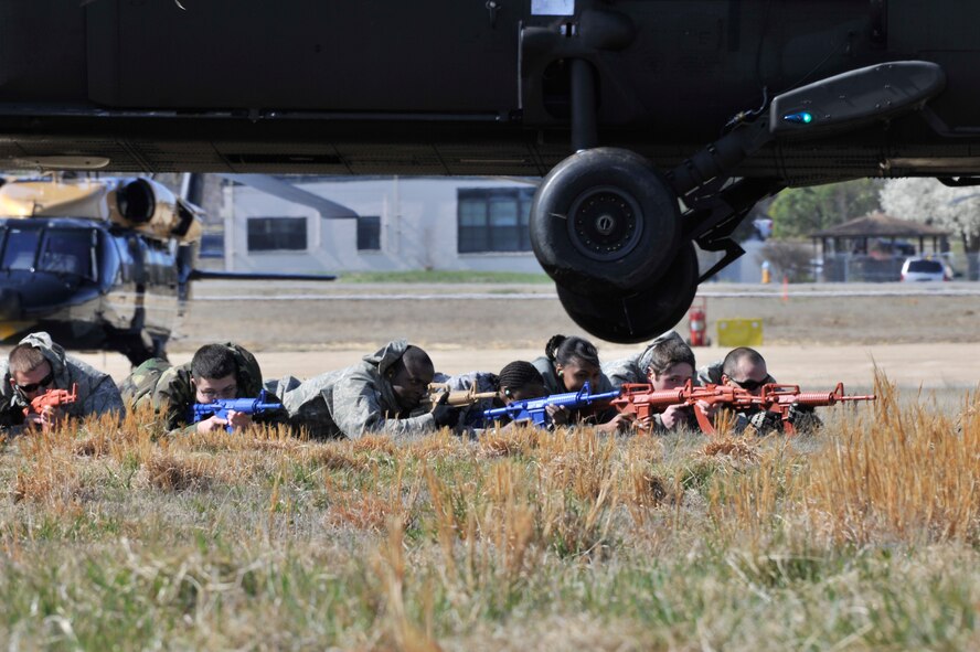 Airmen provide cover while a UH-60 Black Hawk takes off during helicopter deployment readiness training March 25, 2011, at Davison Army Airfield, Va. Airmen are increasingly traveling by helicopters to avoid improvised explosive devices and the direct fire associated with road convoys in a deployed environment. This training program gives them the confidence to execute their core job and not be distracted by the noise, confusion and unfamiliarity of tactical joint air operations.  (U.S. Air Force Photo by Senior Airman Perry Aston) (Released)