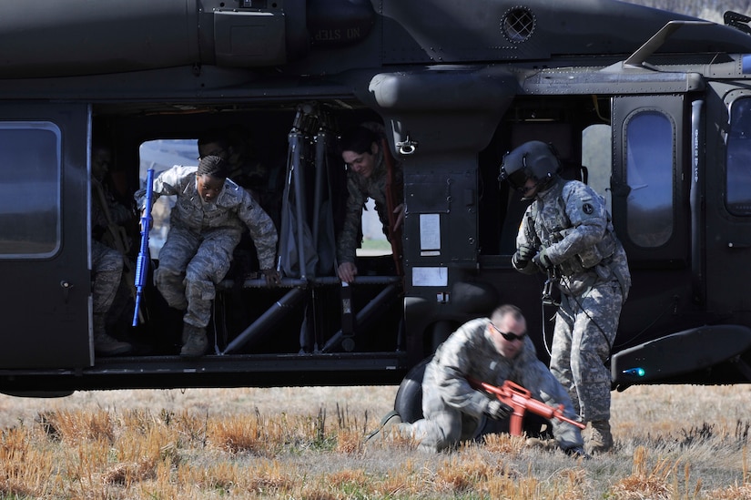 Airmen disembark a UH-60 Black Hawk helicopter during helicopter deployment readiness training March 25, 2011, at Davison Army Airfield, Va. Airmen from all over the national capital region participate in this training to gain confidence in boarding and riding in a helicopter when they deploy downrange.  (U.S. Air Force Photo by Senior Airman Perry Aston) (Released)