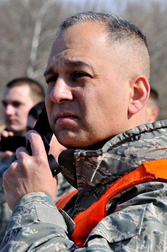 Lt. Col Kjall Gopaul, Joint and Air Staff acting director, and helicopter deployment readiness training instructor, speaks to the pilots of a UH-60 Black Hawk helicopter, while its on final approach to drop off Airmen during a training exercise March 25, 2011, at Davison Army Airfield, Va. The training is performed once a month and more than 2,000 Airman have completed the training since it began in 2003. (U.S. Air Force Photo by Senior Airman Perry Aston) (Released)