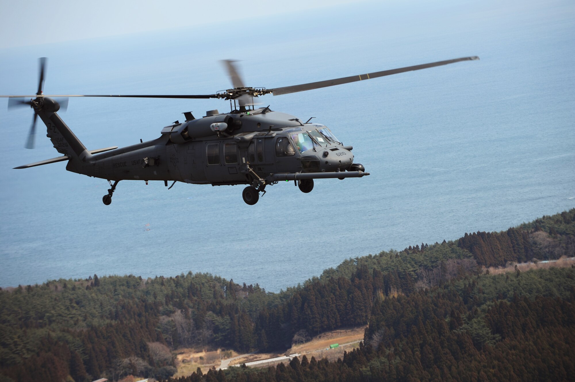 Rescue team members in an HH-60 Pave Hawk conduct search operations over Japan, March 25, 2011, in support of Operation Tomodachi. (U.S. Air Force photo/Tech. Sgt. DeNoris A. Mickle)