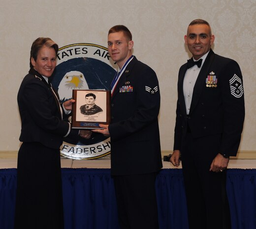 Senior Airman Derek Fisher is awarded the John Levitow award by Col. Martha Meeker and Chief Master Sgt.Jose LugoSantiago at the Airman Leadership School graduation March 24, 2011 on Joint Base Charleston, S.C. The Levitow award is the highest award presented to the Airman that displays the best overall performance evaluation, peer to staff rating and academic ranking. ALS is a six-week course designed to develop Airmen into effective leaders and supervisors. Airman Fisher is with the 437th Operational Support Squadron. Colonel Meeker is the 628th Air Base Wing commander and Chief LugoSantiago is the 628th Air Base Wing command chief. (U.S. Air Force photo/Senior Airman Timothy Taylor)