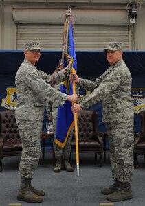 Col. Erik Hansen accepts the 437th Airlift Wing guide-on from Lt. Gen. Robert Allardice at the 437 AW change of command ceremony, March 22 on Joint Base Charleston. Colonel Hansen is the 437 AW commander and General Allardice is the 18th Air Force commander. (U.S. Air Force photo/Senior Airman Timothy Taylor)