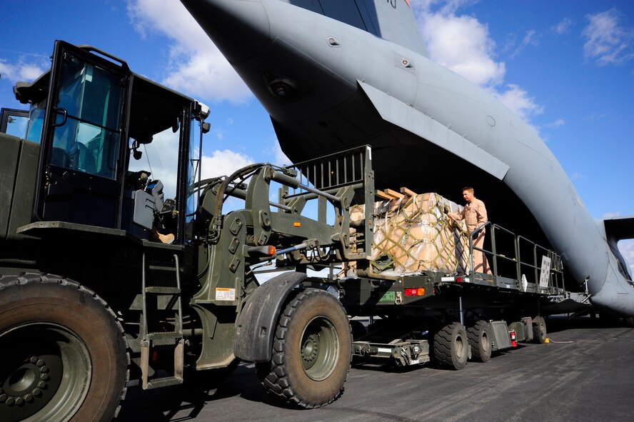 Equipment and cargo are loaded on to a C-17 Globemaster III at Grant County International Airport in Moses Lake, Wash., on March 22, 2011. The mission was in support of Operation Odyssey Dawn. Fairchild Air Force Base, Wash., has seven aircraft and more than 100 Airmen assisting with the operation. (U.S. Air Force Photo/Airman 1st Class Taylor Curry)