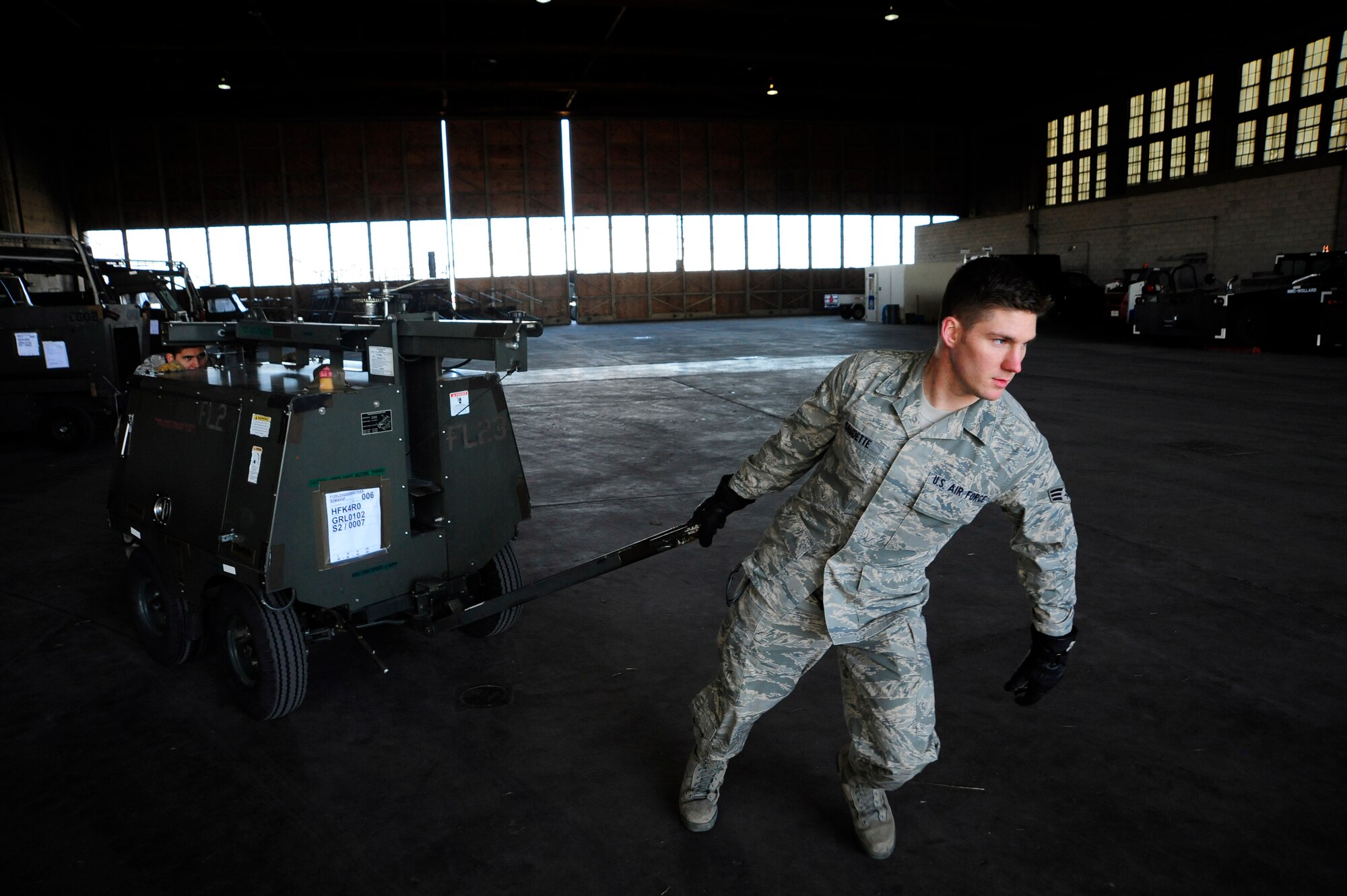 Senior Airman Nathan Gaudette, 92nd Logistics Readiness Squadron, prepares to load a generator heater on a C-17 Globemaster III at Grant County International Airport, Moses Lake, Wash., on March 22, 2011. This mission was in support of Operation Odyssey Dawn. Fairchild Air Force Base, Wash., has seven aircraft and more than 100 Airmen assisting with the operation. (U.S. Air Force Photo/Airman 1st Class Taylor Curry)