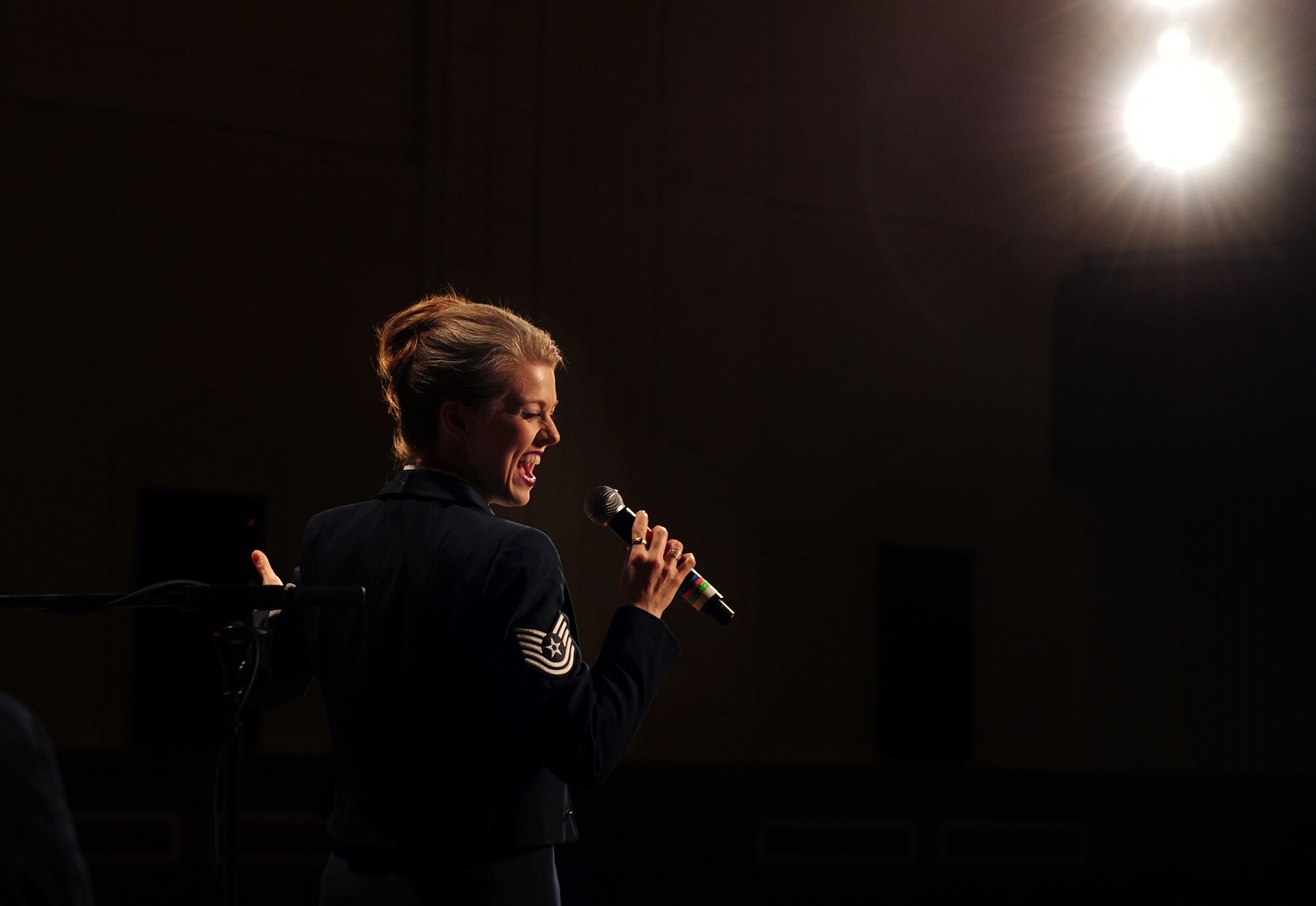 OFFUTT AIR FORCE BASE, Neb. - Tech. Sgt. Krista Joyce, the vocalist with the Heartland of America Band's Noteables jazz ensemble, performs at the Atlantic Middle School's auditorium in Atlantic, Iowa, March 26. Jazz fans faced the blistering cold to see the Air Force ensemble perform for the second time in Atlantic in five months. U.S. Air Force photo by Josh Plueger
