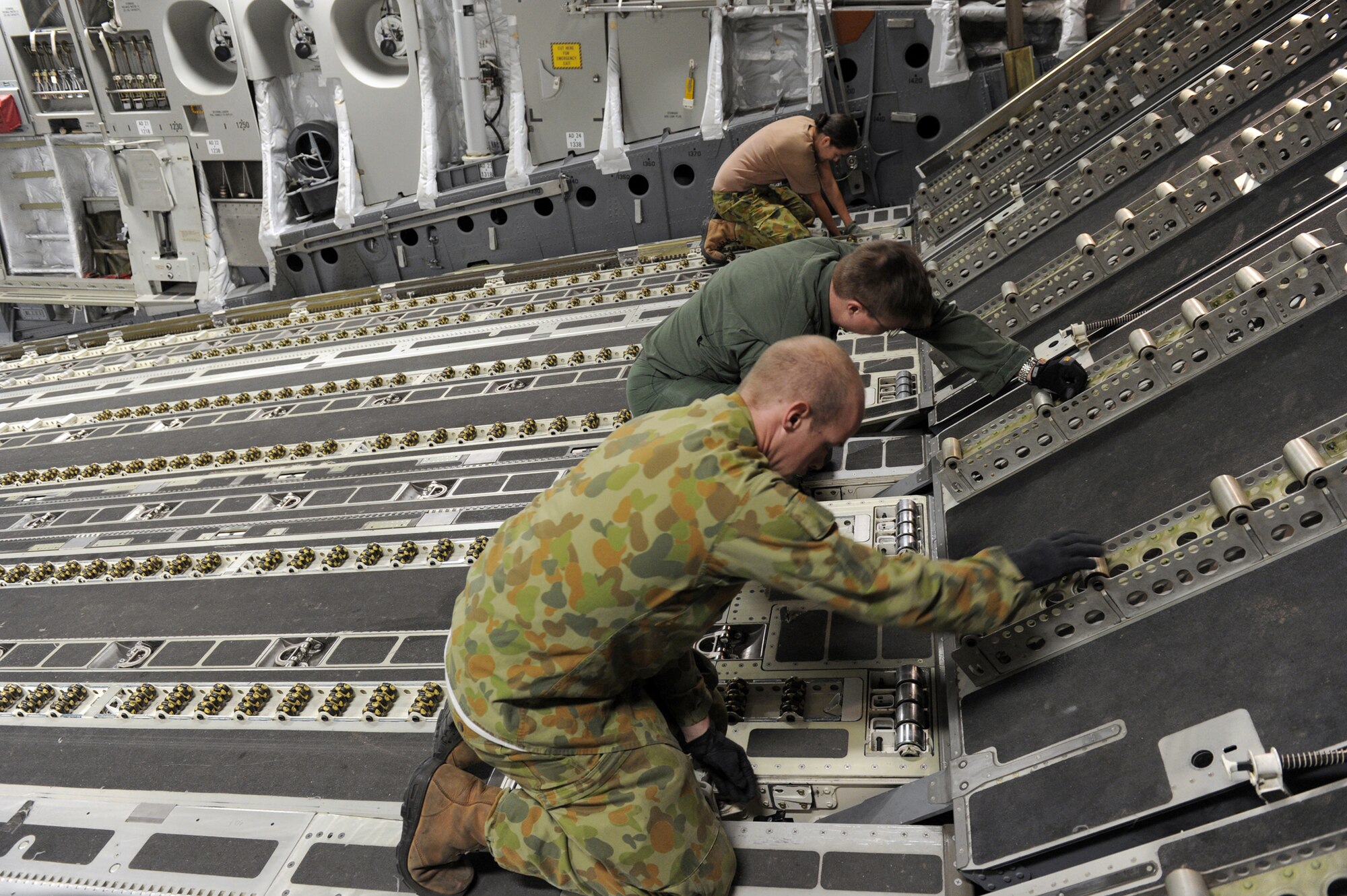 Members of the Royal Australian Air Force prepare their C-17 Globemaster III for cargo prior to take off March 24, 2011, at Sendai Airport, Japan. Yokota Air Base Airmen have had the rare opportunity to work the 36th Squadron and 1st Aircraft Operation Support Squadron from the RAAF during Operation Tomodachi. (U.S. Air Force photo/Senior Airman Michael J. Veloz)
