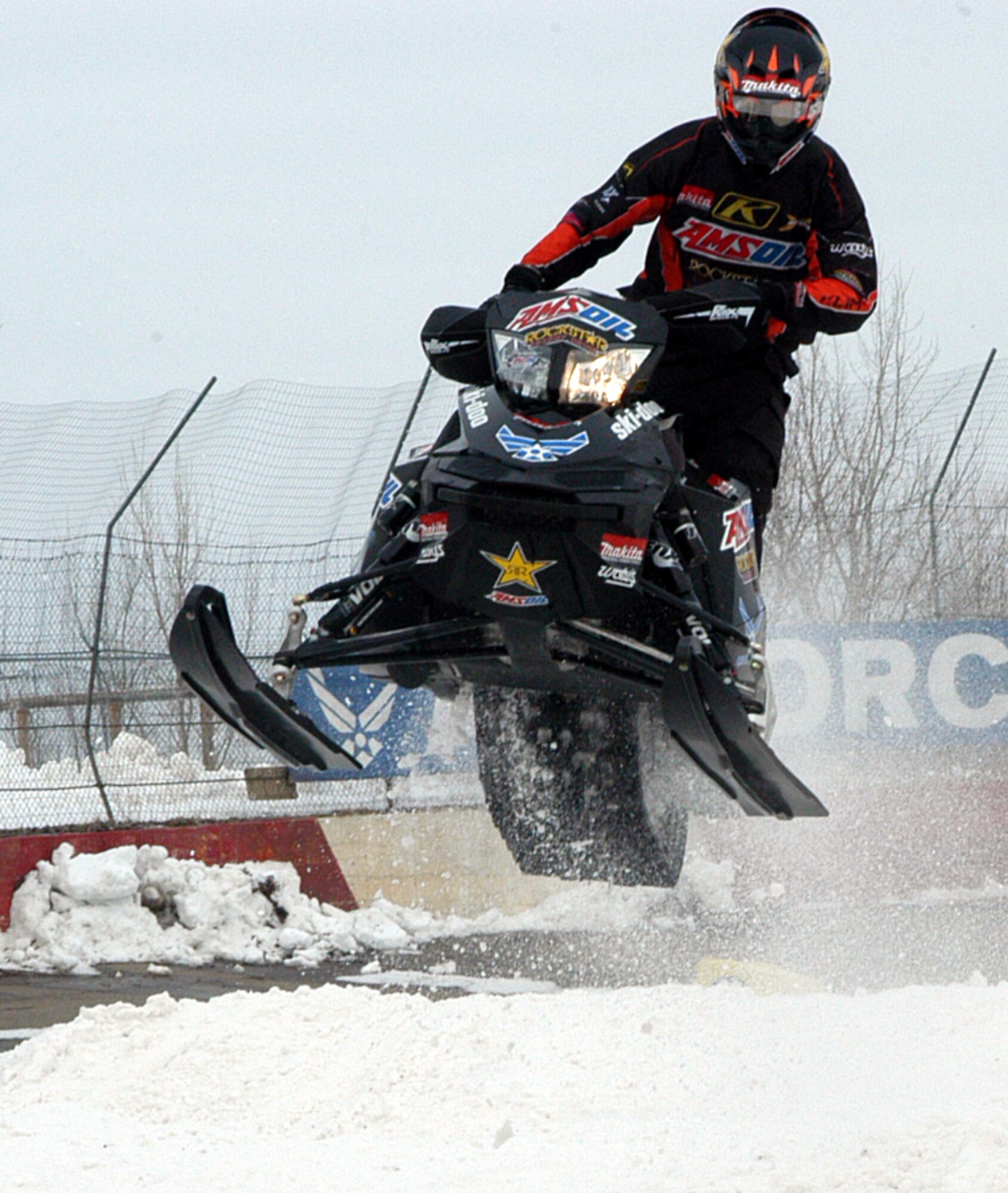 Darrin Meese, Scheuring Speed Sports Semi-Pro rider, gets air during his heat race at the AMSOIL Championship Snocross Series U.S. National snocross event at Elko Speedway, Elko, Minn. on Mar. 13. The 343rd Recruiting Squadron attended the event, set up a booth, and conducted a school visit at Faribault High School in Faribault, Minn. along with Scheuring Speed Sports, which is also sponsored by the U.S. Air Force. The three-day effort also included a 28 member Delayed Entry Program swear-in and generated interest from nearly 200 potential applicants. (U.S. Air Force photo/Tech. Sgt. David J. McCarrison)
